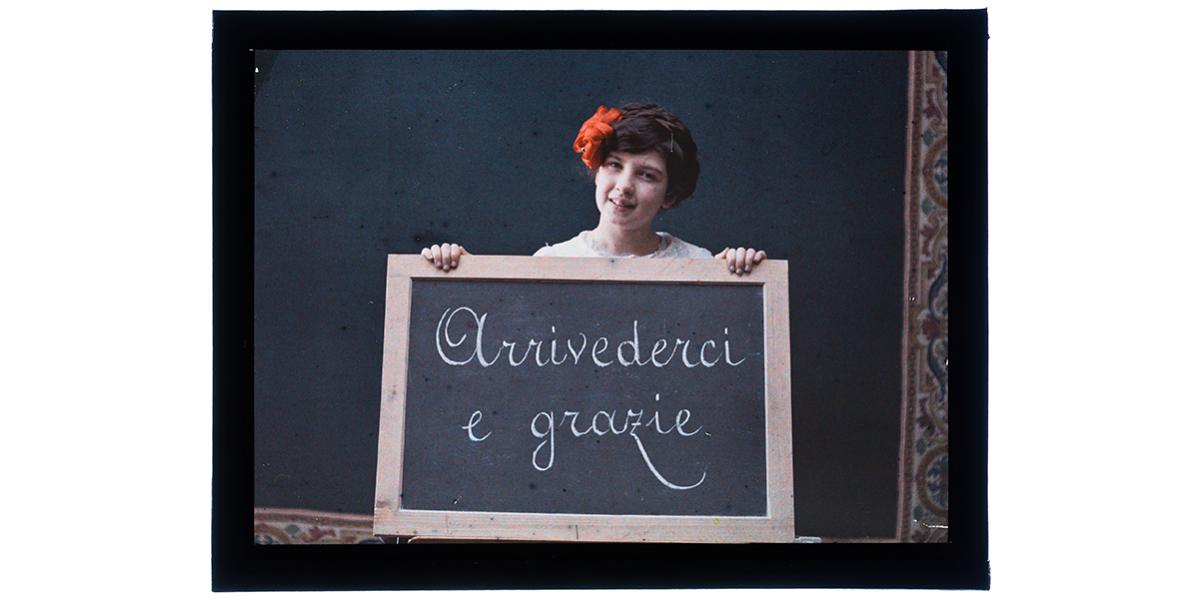 Giorgio Roster, Germana Bronzini shows a blackboard with the inscription 'Goodbye and thank you', ca. 1910, autochrome, 8,9 x 12 cm, Alinari Archives, Roster archive, Florence