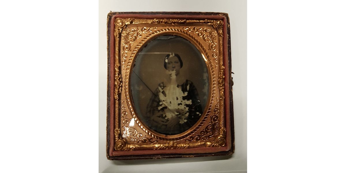 Ambrotype with woman's portrait, damaged and missing the front part of the case.