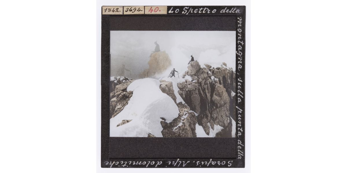 Giorgio Roster, Reproduction from the book by Theodor Wundt "On the Summit of Sorapiss" (1894) / "The spectre of the mountain, on the tip of the Sorapis. Dolomits Alps", March 1895, hand-coloured glass slide, 8 x 9 cm, Alinari Archives, Roster archive, Florence